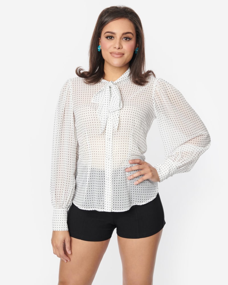 Front of a model wearing a size 1X Unique Vintage White Black Pin Dot Tie Neck Gwen Blouse in White by Unique Vintage. | dia_product_style_image_id:301088